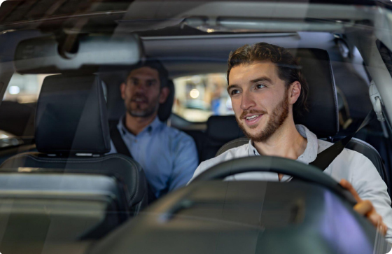 Two people riding in a Rashi rideshare vehicle